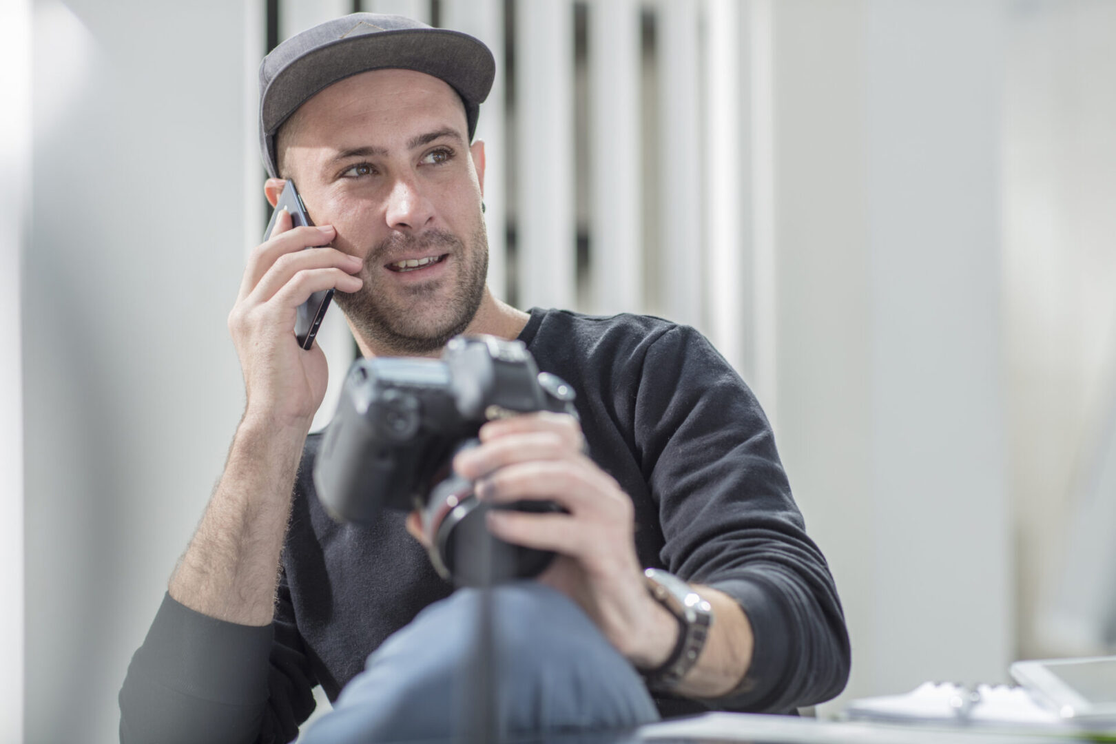 Photographer reviewing images while on a phone call